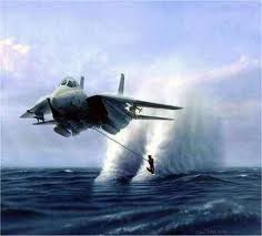 Image of man waterskiing behind F-16 jet.